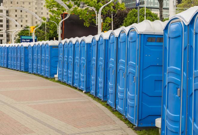 hygienic portable restrooms lined up at a music festival, providing comfort and convenience for attendees in Fairmount